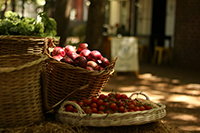 3 wicker basket sthat are holding various fruits