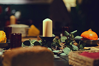 a candle and other table settings on a table